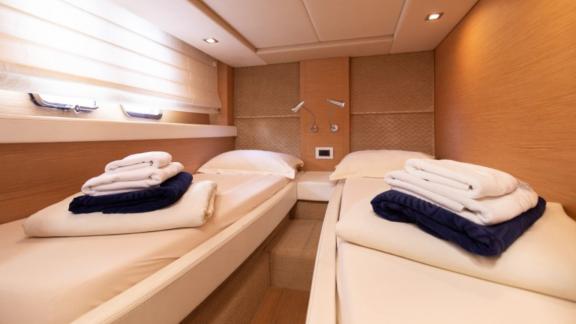 The bedroom of motor yacht Sabijac features two single beds.