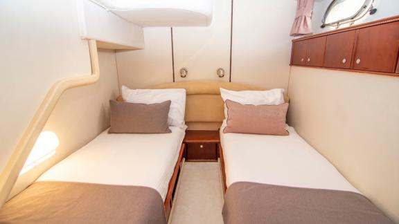 Guest cabin of motor yacht NateWhite with two comfortable beds.