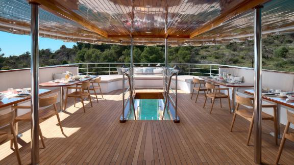 Elegant dining area on the Bellezza yacht with coastal views and a cozy atmosphere.