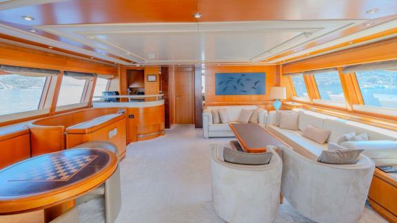 Ariela’s main saloon in Göcek features wide windows, cozy seating and elegant furnishings for comfort.