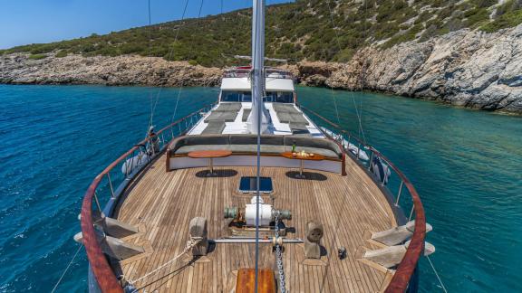 Relax on the spacious sun deck of Gulet Vamos 1 in a serene setting.