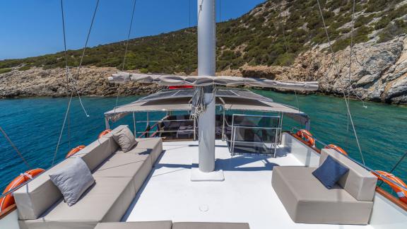 Relax on the comfortable seating areas of Gulet Vamos 1 in a picturesque bay.