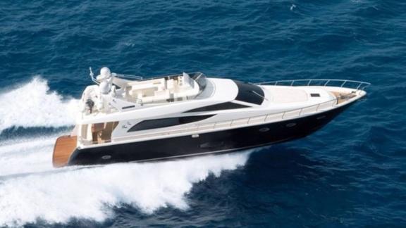 The Venus Secrets yacht speeds through blue waters, catching attention with its sleek design and deck.