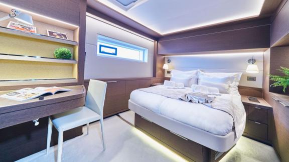 Cozy cabin with double bed, desk, and stylish lighting on Lagoon Seventy 7.