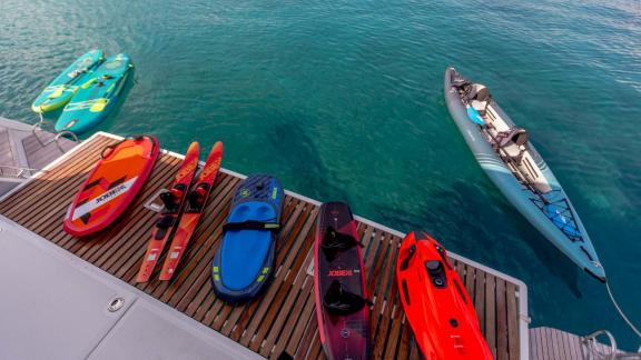 Kayak, paddleboards, and water skis on the yacht deck, ready for adventure