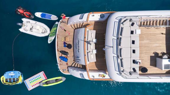 Water sports and activities around a luxurious yacht.