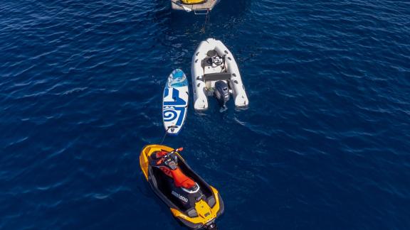 Atina'da, Spirit L yatına ait jetski, şişme bot ve paddleboard mavi denizde.