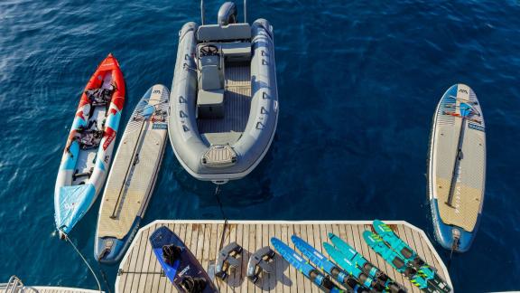 An Deck des Katamarans Valium 55 befinden sich Paddleboards, Wasserski und ein Schlauchboot für Wassersportaktivitäten.