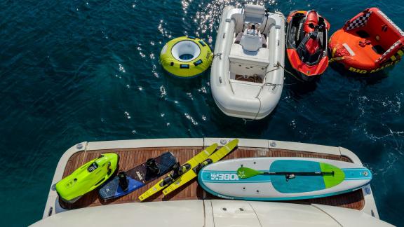 Miraval yacht offers paddleboard, water skis, and inflatable toys for water fun.