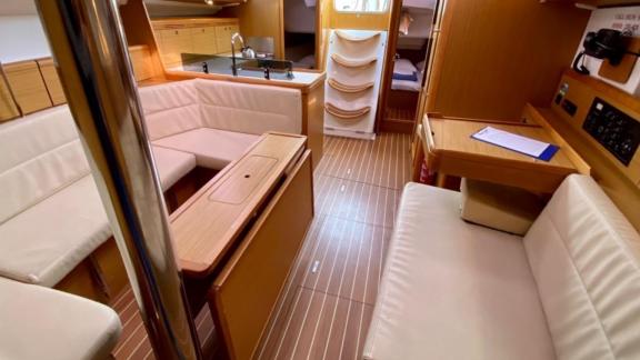 The spacious interior seating area of the sailing yacht Winter Breeze offers an elegant and comfortable design.