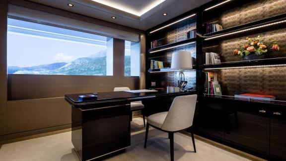 Stylish desk, bookshelves, and sea views.