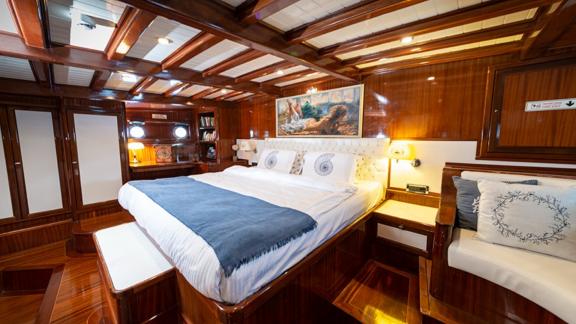 A comfortable and spacious bedroom. You can see a king size bed, good lighting and a picture