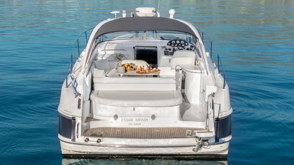 Aegean Blue features an aft seating area for daily motor yacht charters and private boat tours in Mykonos.