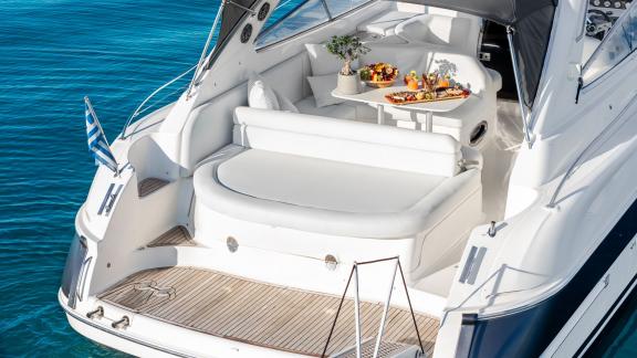 Aegean Blue features an aft lounge area for daily yacht charters and private bay tours in Mykonos.