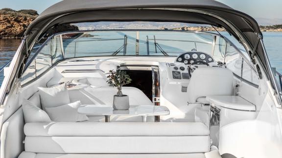 Aegean Blue features a cockpit seating area for daily motor yacht charters and private island tours in Mykonos.