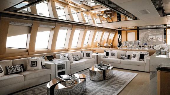 Experience the modern lounge of Ak Royalty yacht with comfortable seating and elegant decor.