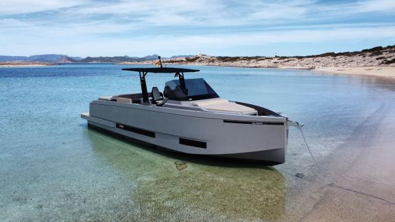 Motor yacht Alegria anchored in a serene bay with turquoise waters, showcasing its modern and elegant design.