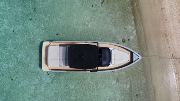 Die Motoryacht Alegria ankert in flachem türkisfarbenem Wasser und bietet eine geräumige Deckfläche für Entspannung.