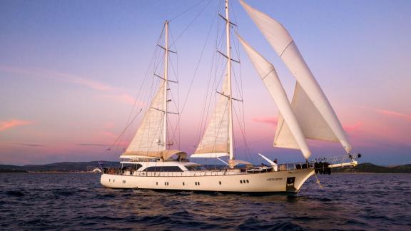 Die Gulet-Yacht Alessandro 1 bei Split segelt malerisch im Abendlicht.