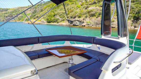 The comfortable seating area on the upper deck of Alfa F yacht offers enjoyable moments with a sea view.