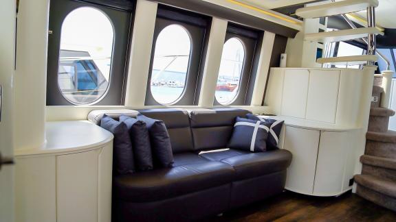 The comfortable seating area in the interior of Alfa F yacht offers a great view through large windows.