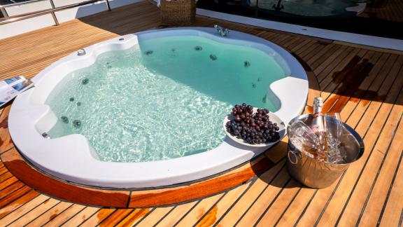 The jacuzzi on the deck of Almila motor yacht in Marmaris offers a luxurious experience with grapes and champagne beside