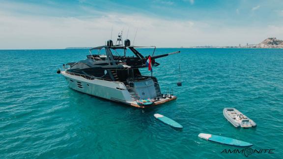 The Ammonite motor yacht is seen on the water with water sports equipment.