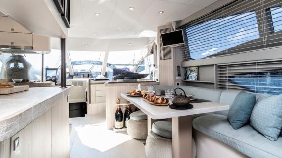 The modern dining area on the Ammonite motor yacht stands out with its elegant table setting and comfortable seating.