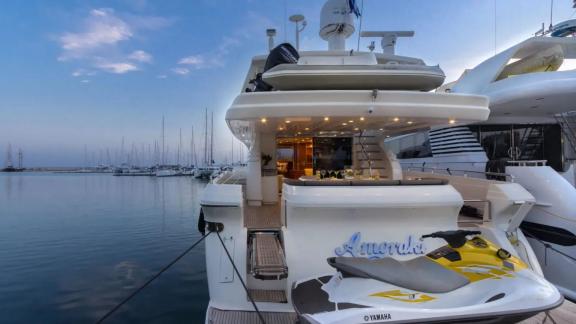 Rear deck of yacht Amoraki with a jet ski and lighting.