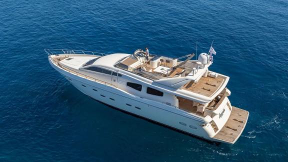 Amoraki yacht at sea, featuring upper deck and spacious rear area.