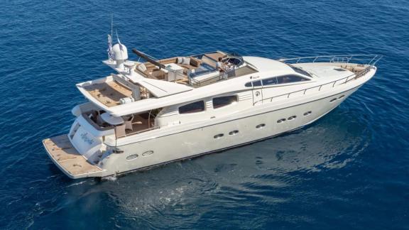 Amoraki yacht at sea, showcasing its spacious deck from a rear view.