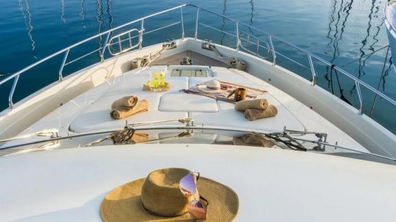 Towels, drinks, and a hat on the front deck of yacht Amoraki.