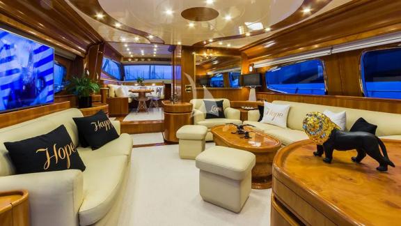 The spacious salon of yacht Amoraki features comfortable sofas and elegant decor.