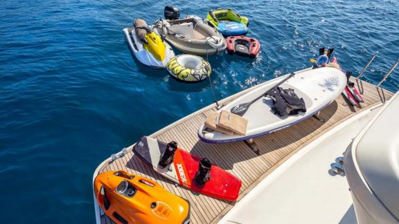 Amoraki yacht features a paddleboard, jet ski, and various water toys.