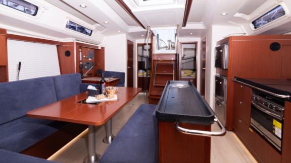 The saloon of the yacht Anse offers a spacious living area with a large seating area and kitchen.