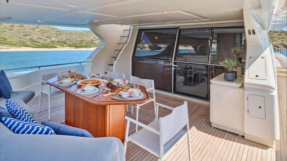 Apeiron Blue in Lavrion features outdoor dining arrangements and a refined yacht charter experience on deck.
