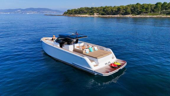 Among Cannes yacht charter options Arlias motor yacht shows aft seating area and easy access to the sea.