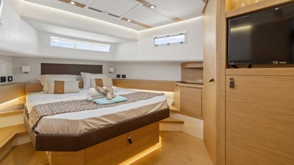 Among Cannes yacht charter options Arlias motor yacht shows cabin with large bed and modern interior.