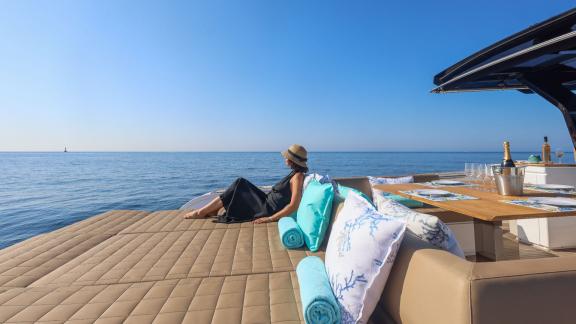 Among Cannes yacht charter options Arlias motor yacht shows aft sunbed with seating and sea view.