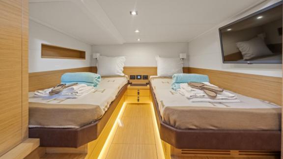 Among Cannes yacht charter options Arlias motor yacht shows cabin with two single beds and bright interior.