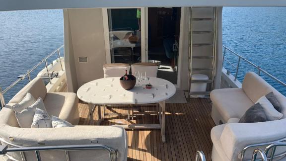 The aft deck of the trawler yacht Atıl in Göcek features a comfortable seating area.