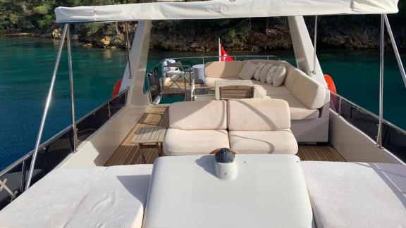 The upper deck of the trawler yacht Atıl in Göcek features a comfortable seating area.