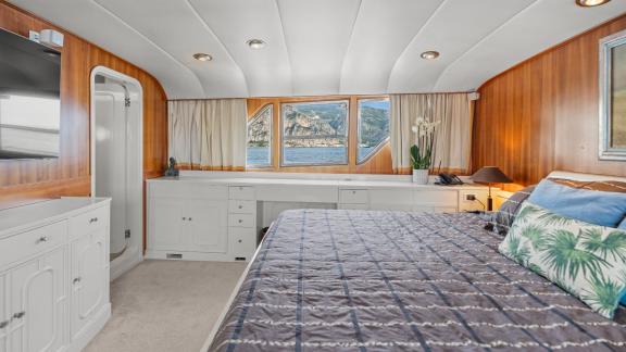Among Cannes daily yacht rental options Ava motor yacht cabin shows bed with sea view window.