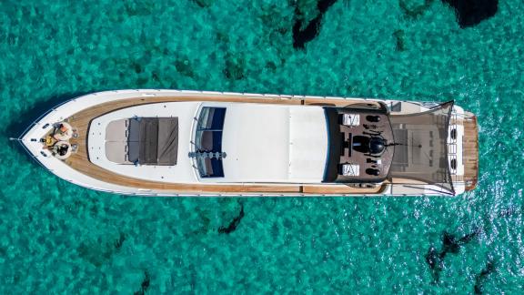 Impressive aerial view of the motor yacht Aya One floating over turquoise waters.