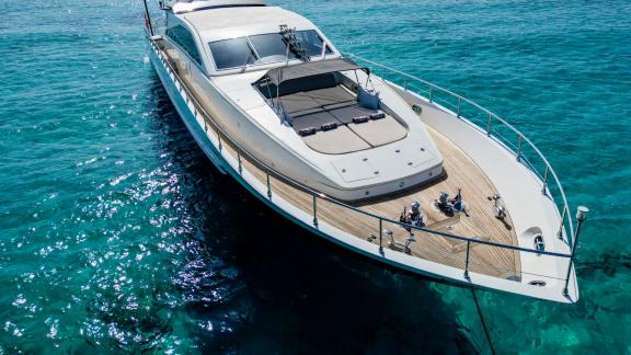 The spacious foredeck of motor yacht Aya One anchored in turquoise waters.