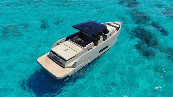 Rear top view of daily motor yacht Bambino near the coast of Ibiza.