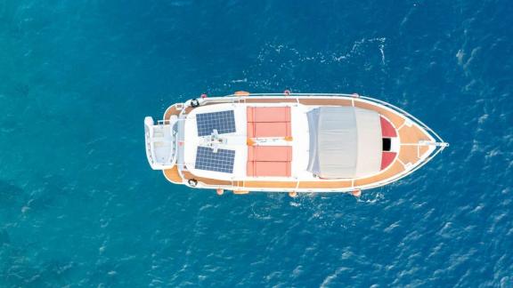 Red cushions and solar panels visible on the upper deck of Barbaros 3 lobster yacht.
