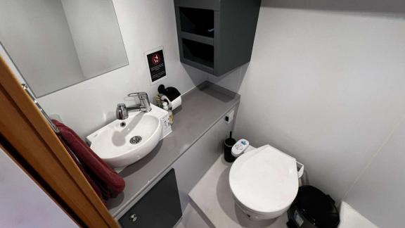 Small but functional bathroom with sink and toilet on Barbaros 3 yacht.