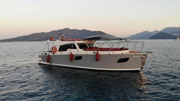 Barbaros 3 lobster yacht rests at anchor with red cushions off Marmaris coast.