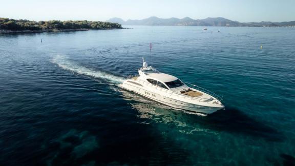 Among Cannes daily yacht rental options Best Mountain is seen cruising in clear water with scenic surroundings.